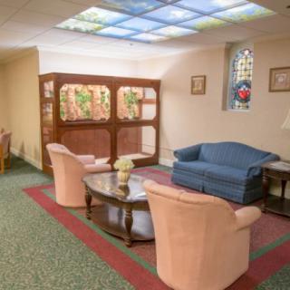 A cozy lounge area with comfortable seating and stained glass accents.