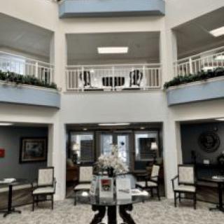 A spacious lobby area with elegant furniture and balconies on two levels.