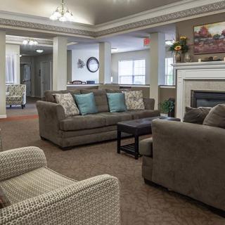 A cozy living room with sofas and a fireplace.