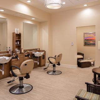 A modern salon with styling chairs and mirrors, designed for hairdressing services.