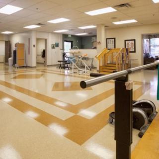 A spacious rehabilitation center equipped with exercise equipment and facilities for physical therapy.