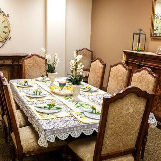 An elegantly decorated dining room with a set table and upholstered chairs.