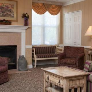 A cozy living room with a fireplace, sofas, and a coffee table.