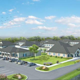 Aerial view of a modern residential community with well-maintained landscaping and parking facilities.