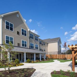 A modern residential apartment building under a clear blue sky.