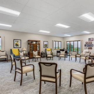 A spacious meeting room arranged in a circle with chairs, ready for a group discussion.