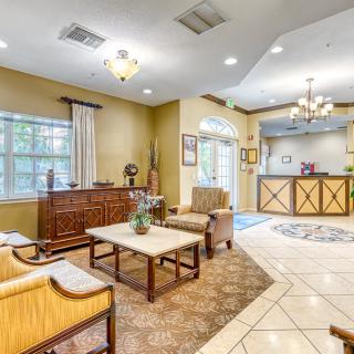 A well-lit lobby with comfortable seating and a reception desk.