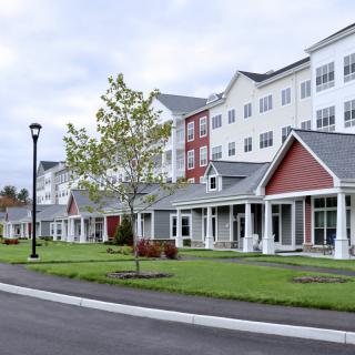 A modern residential housing complex with well-maintained landscaping.