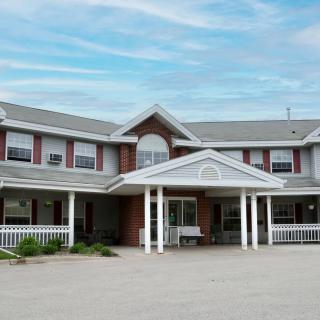 A two-story residential building with a prominent entrance and porch.