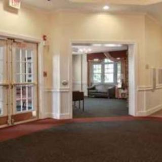 A spacious interior lobby featuring a welcoming atmosphere with natural light, plush furniture, and well-defined spaces.