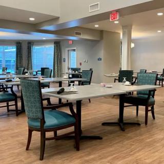 An empty dining area with neatly arranged tables and chairs in an indoor setting.