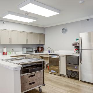 A modern kitchen with stainless steel appliances and wooden cabinets.