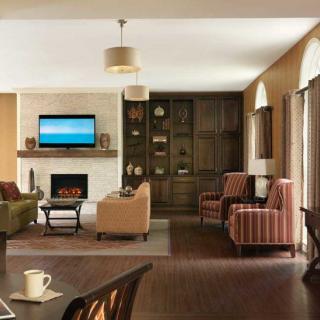 A modern and cozy living room with a fireplace and comfortable seating.