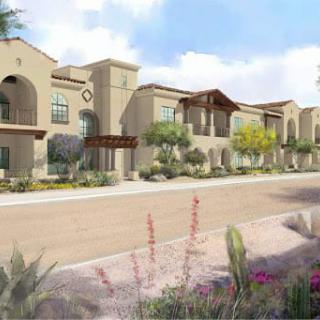 A modern residential building with a landscaped front.
