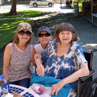 A cheerful gathering of friends enjoying a sunny day outdoors.