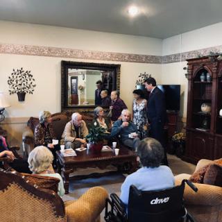 A cozy indoor gathering with a group of people engaged in conversation.