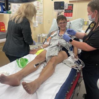 Medical professionals attending to a patient in an emergency room.