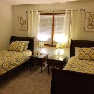 A cozy bedroom with twin beds and matching decor.