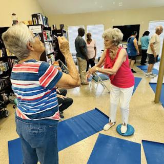 Seniors participating in a fitness class focused on balance and coordination.