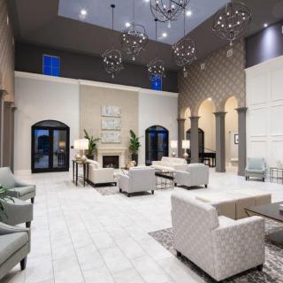 A luxurious, modern lobby with elegant chandeliers and stylish seating.