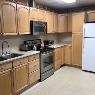 A well-organized kitchen featuring wooden cabinets and essential appliances.