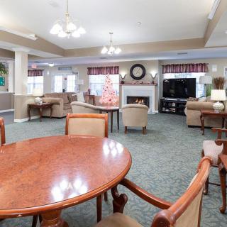 A spacious living room with a seating area, fireplace, and television.