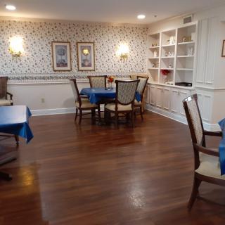 A cozy dining room with wooden floors and elegant furniture.
