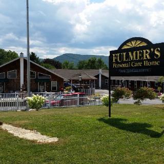 An inviting restaurant with outdoor seating set against a mountainous backdrop.