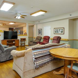 A cozy living room setup featuring comfortable seating and a television.
