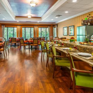 A spacious dining area with elegant decor and wooden flooring.