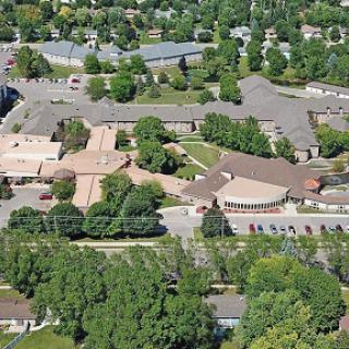 An aerial view of a residential complex surrounded by lush greenery.