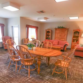 A cozy living and dining area with wooden furniture and a warm ambiance.