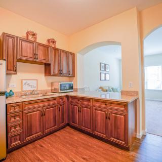 A cozy kitchen with wooden cabinets and modern appliances.