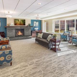 A beautifully designed living room featuring a cozy fireplace and modern seating.