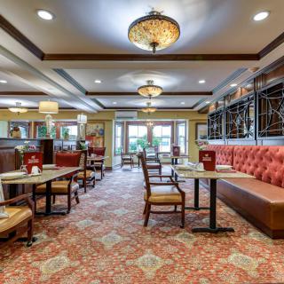 A cozy restaurant interior with elegant lighting and comfortable seating arrangements.