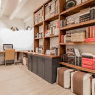 Modern office space with wooden bookshelves and a work desk.