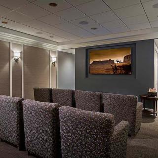 A cozy home theater with comfortable seating and a large screen.