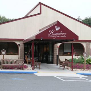 A winery entrance with outdoor seating and distinctive architecture.