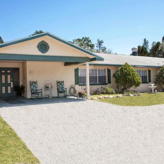 A suburban house with a spacious driveway and a well-maintained front yard.