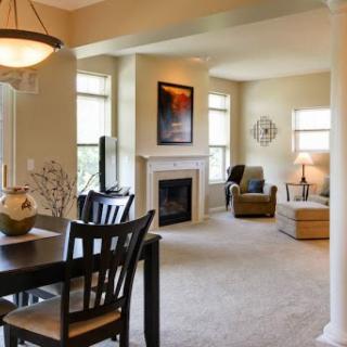 A cozy and inviting living space with a dining area, fireplace, and comfortable seating.