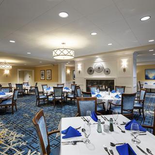An elegant dining room with tables set for service.