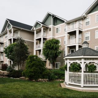 A peaceful residential complex with a gazebo and well-maintained landscaping.