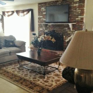 Cozy living room with a brick fireplace and modern decor.