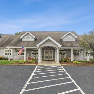 A well-maintained building with a prominent entrance and neatly landscaped surroundings.