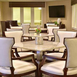 A modern dining and meeting area with elegant chairs and tables.