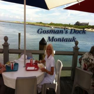 Guests enjoying a meal at Gosman's Dock in Montauk with a scenic waterfront view.