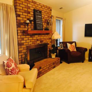 Cozy living room with a brick fireplace and comfortable seating.