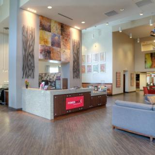 A modern lobby interior with a reception desk and seating area.