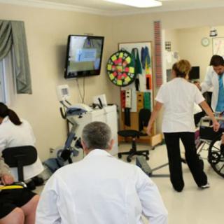 A healthcare setting with professionals assisting patients in rehabilitation exercises.