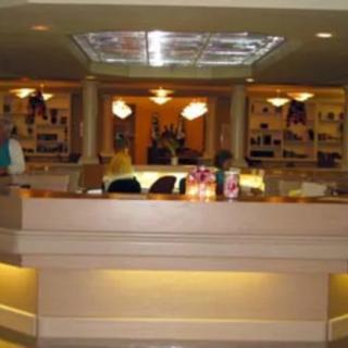 A hotel reception desk area with ambient lighting.